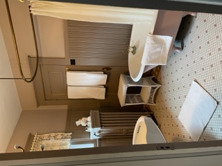 The Isabella Room's private bath features a clawfoot tub with a brass shower ring.