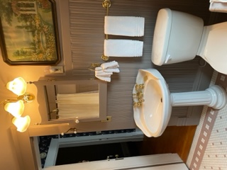 A pull-chain water closet and a pedastal sink complete the old-fashioned feel of the Isabella Room's private bath.