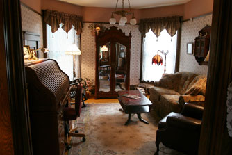 The den is off the main parlor area, and can be closed off with pocket doors.