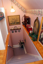 The back stairs has more of an attic feel, but is a showcase spot for antique art and memorabilia.