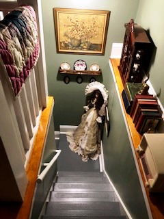 The back stairs has more of an attic feel, but is a showcase spot for antique art and memorabilia.
