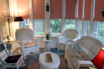 The east porch, completely enclosed, is a cheerful breakfast place on summer days.
