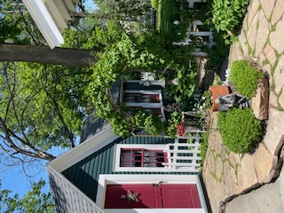 A dream garden welcome - the entrance to the private backyard is alongside a cottage like tool shed
