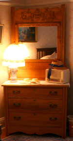 A private bath nestles under the back third-floor stairs, with a view of the carriage house from the window.
