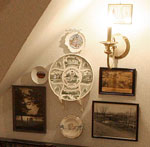 Antique pictures and collectible plates form a collage on the Heritage Suite's private sitting room wall.