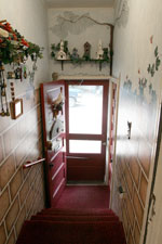 The entrance from the driveway - trompe l'oeil painting of a garden wall.